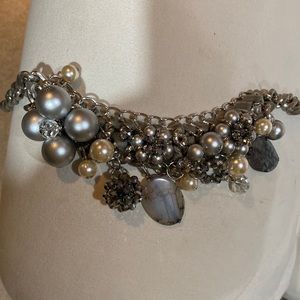 Am selling a silver pearl and stone necklace. Very vintage in its styling.